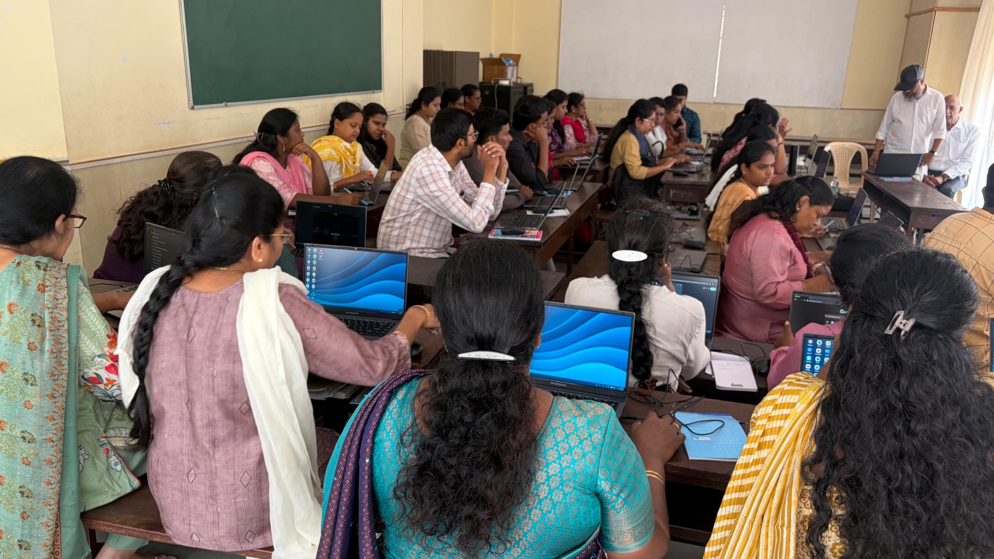 Participants working on laptops during the training