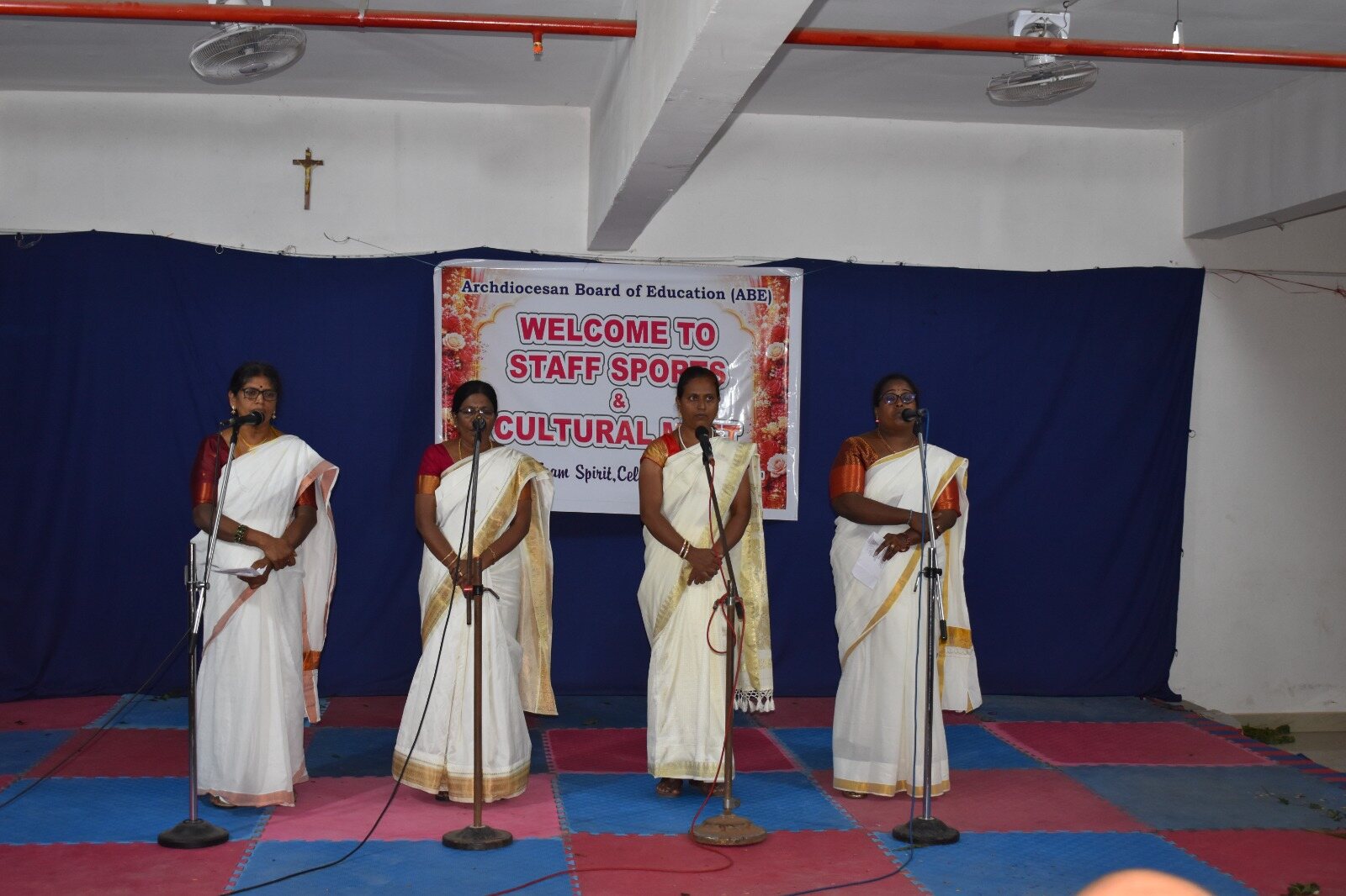 Staff members performing on stage